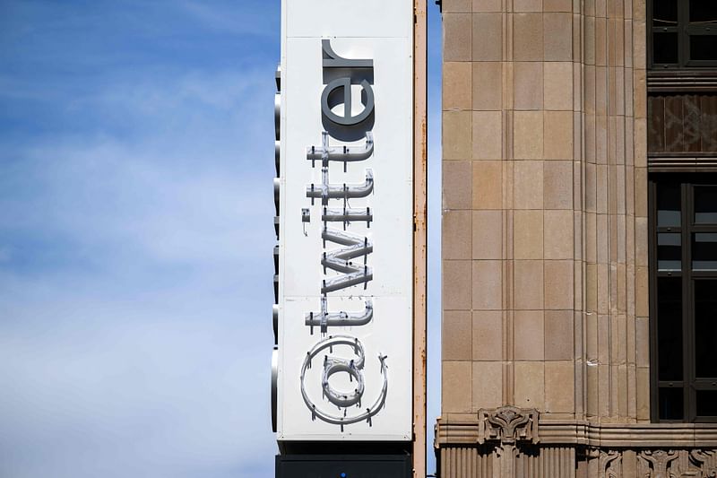 Twitter's sign is seen partially removed after San Francisco Police stopped the changing of their sign to the company’s new name, 'X' at Twitter’s corporate headquarters office in San Francisco, California on 24 July, 2023.