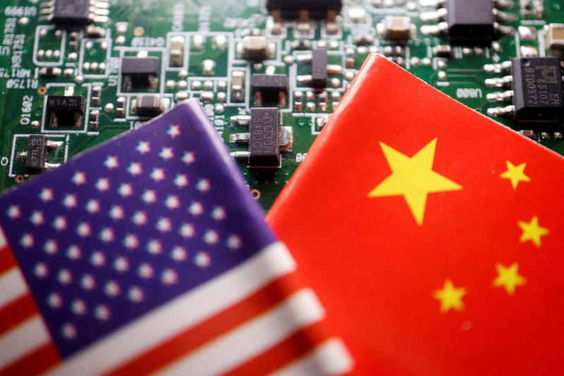 Flags of China and US are displayed on a printed circuit board with semiconductor chips, in this illustration picture taken on 17 February, 2023.