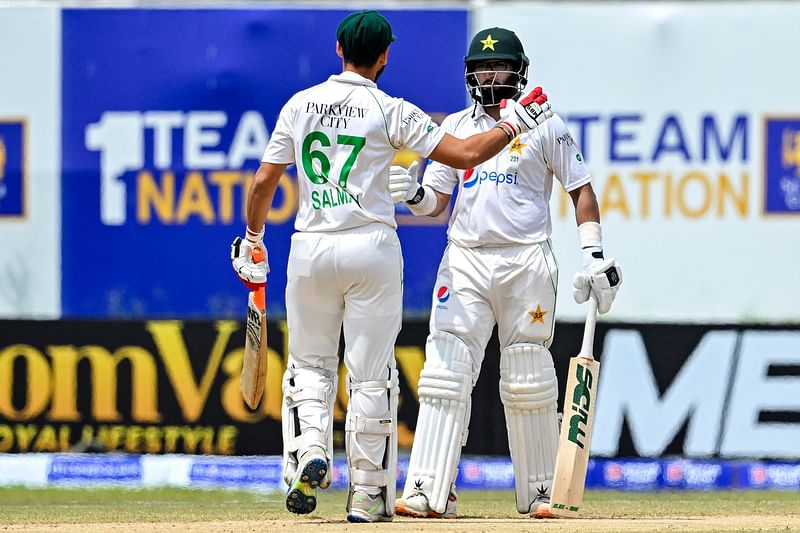 Pakistan's Imam-ul-Haq (R) and Agha Salman celebrate after Pakistan won by 4 wickets on the fifth and final day play of the first cricket Test match between Sri Lanka and Pakistan at the Galle International Cricket Stadium in Galle on 20 July, 2023