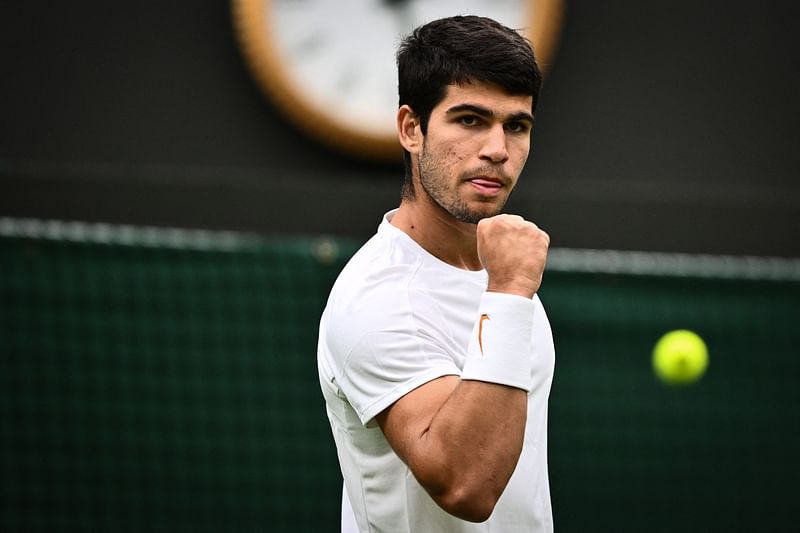 Spain's Carlos Alcaraz celebrates after scoring a point to France's Jeremy Chardy during their men's singles tennis match on the second day of the 2023 Wimbledon Championships at The All England Tennis Club in Wimbledon, southwest London, on 4 July, 2023.