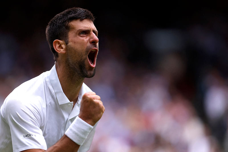 Serbia's Novak Djokovic celebrates winning the third set during his quarter final match against Russia's Andrey Rublev