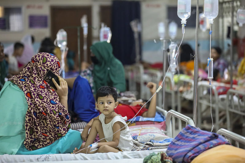 A boy sits on the hospital bed as he has been hospitalised with dengue in the capital’s Mugda Medical College and Hospital on 11 July 2023.