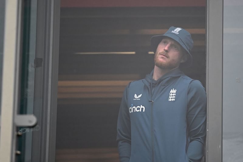 England's captain Ben Stokes looks on from the balcony as rain delays the start of play on day five of the fourth Ashes Test between England and Australia at Old Trafford cricket ground in Manchester, England on 23 July 2023