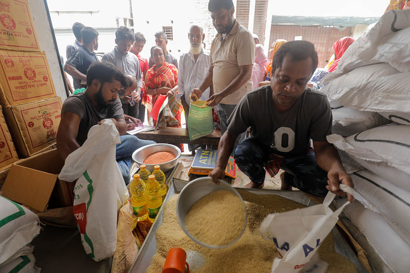 A worker packs rice at a shop at Jorakal Bazar, Khulna on 16 July 2023.