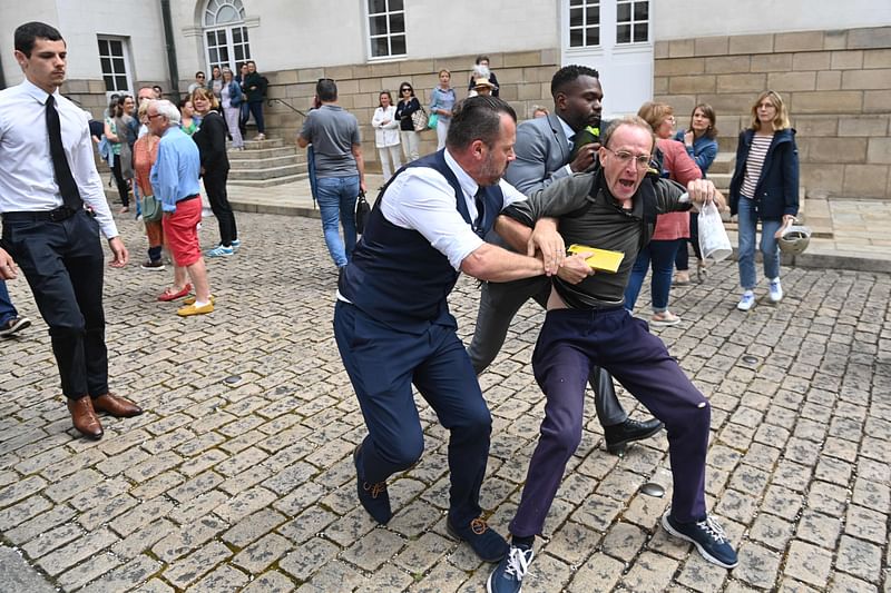 Security personnel remove a protester during a nationwide action in Nantes, western France on 3 July, 2023