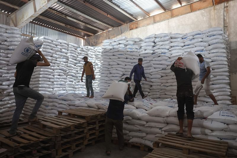 Workers unload bags of aid at a warehouse near the Syrian Bab al-Hawa border crossing with Turkey, on 10 July, 2023