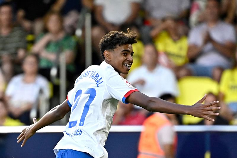 Barcelona's Spanish forward Lamine Yamal celebrates after Polish forward Robert Lewandowski (not seen) scored during the La Liga match between Villarreal CF and FC Barcelona at La Ceramica stadium in Vila-real on 27 August 2023