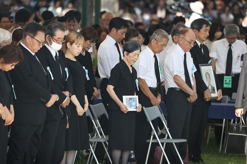 Attendees observe a moment of silence during a ceremony to mark the 78th anniversary of the world's first atomic bomb attack, at the Peace Memorial Park in Hiroshima on 6 August, 2023.