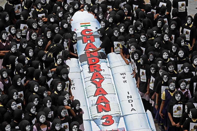 Students with painted faces surround a replica of the Chandrayaan-3 spacecraft in Chennai on 22 August, 2023. The Indian Space Research Organisation (ISRO) confirmed that the lander module of the Chandrayaan-3, which means “Mooncraft” in Sanskrit, had “successfully separated” from the propulsion module six days ahead of a planned landing slated for 23 August