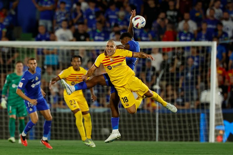 Barcelona's Spanish midfielder Oriol Romeu vies with Getafe's Honduran forward Anthony Lozano during the La Liga match between Getafe CF and FC Barcelona at the Col. Alfonso Perez stadium in Getafe on 13 August 2023