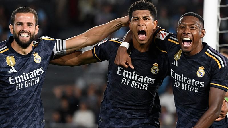 Real Madrid's English midfielder Jude Bellingham celebrates his goal with Spanish defender Nacho Fernandez and Austrian defender David Alaba during the La Liga match between RC Celta de Vigo and Real Madrid CF at the Balaidos stadium in Vigo on 25 August 2023