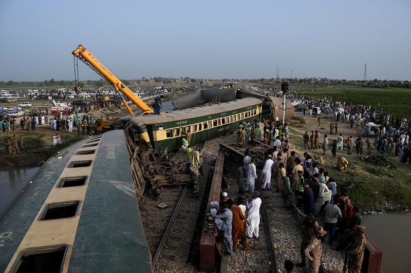 A crane arrives to clear the tracks after a train derailed in Sarhari town in district Sanghar, Pakistan August 6, 2023