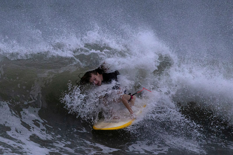 A surfer rides the swells ahead of Hurricane Idalia in Clearwater Beach, Florida, U.S., August 29, 2023