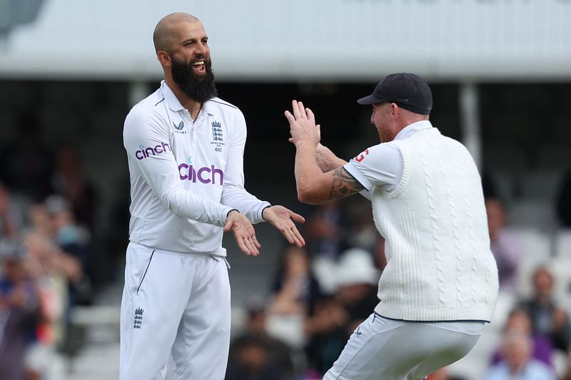 England's Moeen Ali celebrates with England's captain Ben Stokes after taking the wicket of Australia's Travis Head on day five of the fifth Ashes Test between England and Australia at The Oval cricket ground in London on 31 July 2023