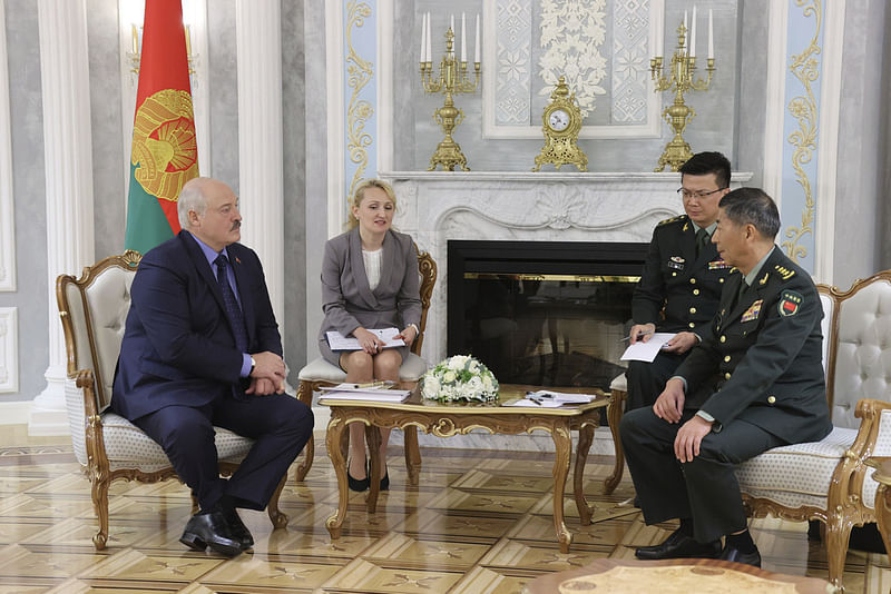 In this handout photo released by Belarusian Presidential Press Office, Belarusian President Alexander Lukashenko, left, and China's Defense Minister Gen. Li Shangfu, right, speak during their talks in Minsk, Belarus, Thursday, Aug. 17, 2023.