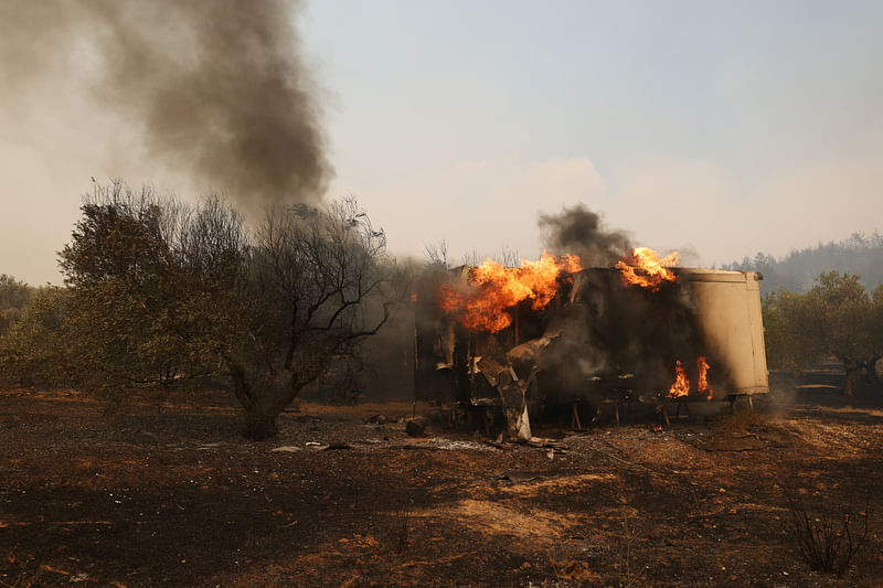 A container is seen in flames as a wildfire burns in the village of Avantas, near Alexandroupolis, in the region of Evros, Greece, August 22, 2023