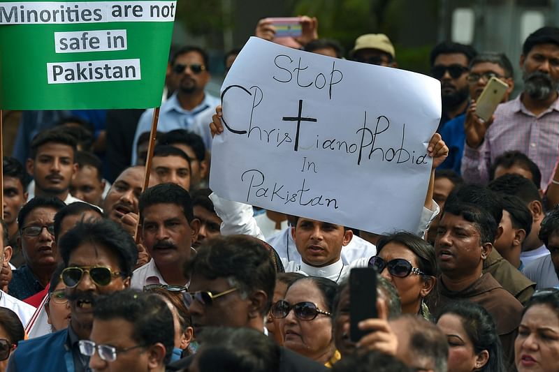 Civil society activists and members of the Christian community hold placards as they take part in a protest to condemn the attacks on churches in Pakistan, in Karachi on 18 August, 2023