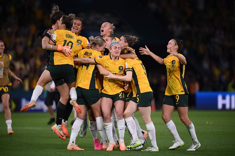 Australian players celebrate their win at the end of the Australia and New Zealand 2023 Women's World Cup quarter-final match between Australia and France at Brisbane Stadium in Brisbane on 12 August 2023