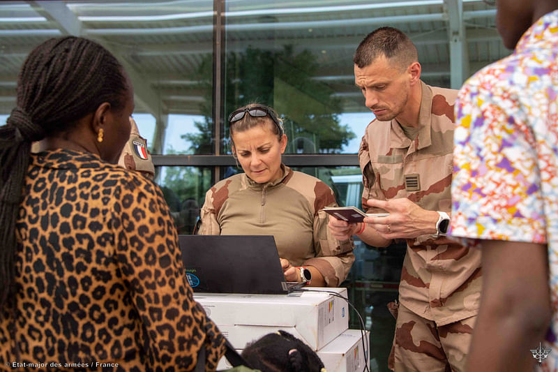 French soldiers welcome and register French nationals, other European citizens as well as other nationalities, who have been evacuated from Niger, days after a junta seized power in the West African country, at the Diori Hamani International Airport in Niamey, Niger in this picture released on August 2, 2023