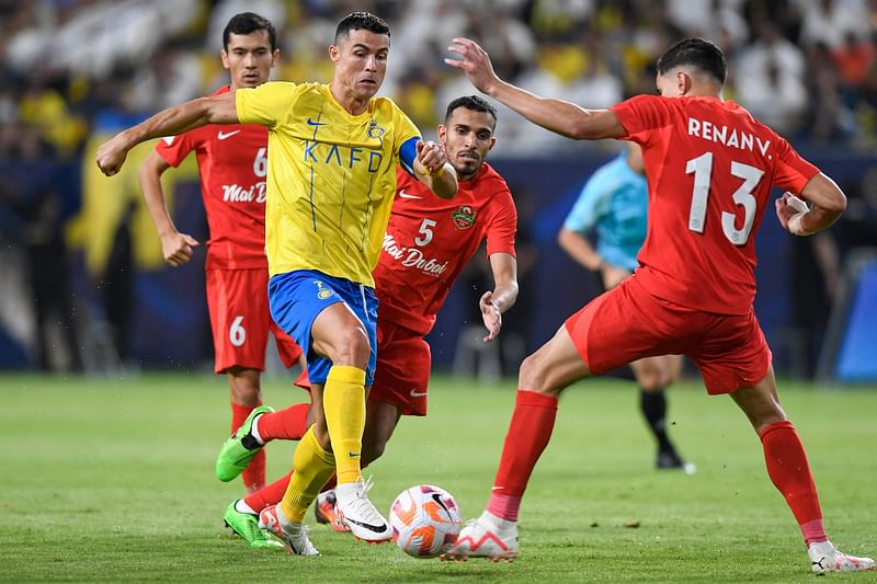 Al-Nassr's Portuguese forward Cristiano Ronaldo vies for the ball with Shabab Al-Ahli's Brazilian defender Renan during the AFC Champions League playoff between Saudi's Al-Nassr and UAE's Shabab Al-Ahli at the King Saud University Stadium in Riyadh on 22 August 2023.