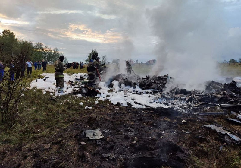 Firefighters work amid aircraft wreckage at an accident scene following the crash of a private jet in the Tver region, Russia, August 23, 2023