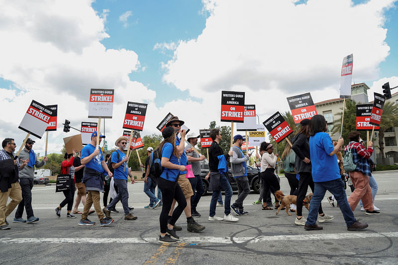 Workers and supporters of the Writers Guild of America protest outside Universal Studios Hollywood after union negotiators called a strike for film and television writers, in the Universal City area of Los Angeles, California, US, 3 May, 2023.