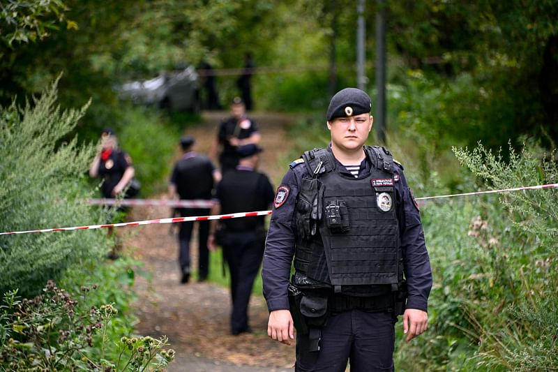 A police officer blocks off the site where a Ukrainian drone targeting the Russian capital was downed by air defence system, in western Moscow on August 11, 2023