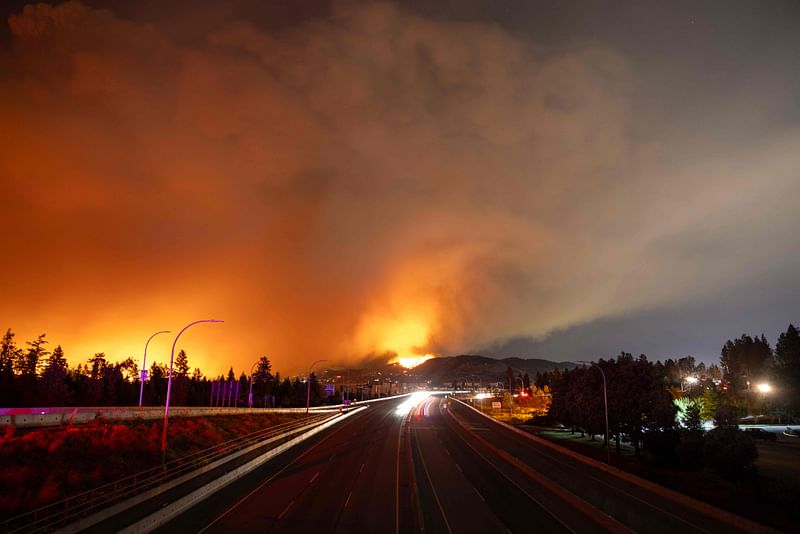 The McDougall Creek wildfire burns in the hills West Kelowna, British Columbia, Canada, on 17 August, 2023, as seen from Kelowna