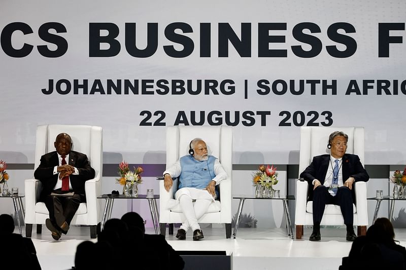 South African President Cyril Ramaphosa (L), Prime Minister of India Narendra Modi (C) and China's Minister of Commerce Wang Wentao (R) attend the 2023 BRICS Summit at the Sandton Convention Centre in Johannesburg on 22 August, 2023