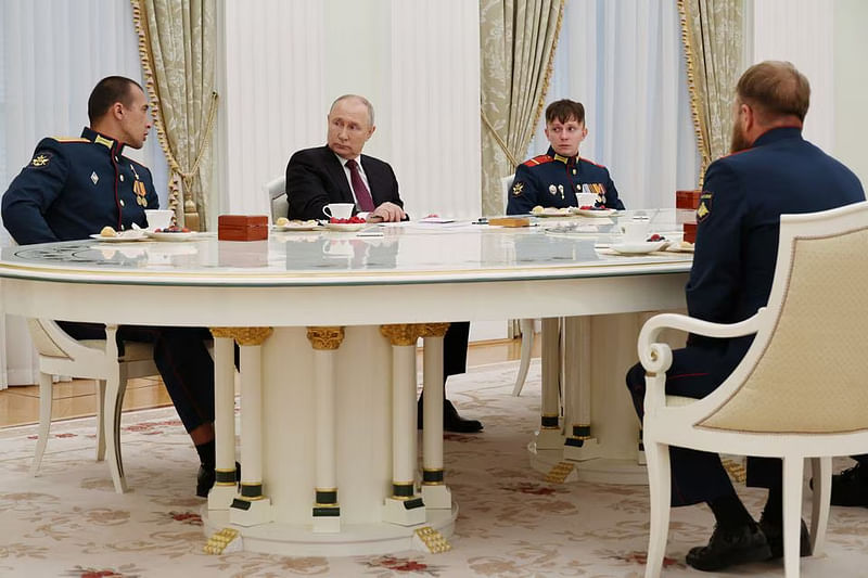 Russian President Vladimir Putin meets with the crew of the Alyosha T-80 tank, which destroyed a Ukrainian armoured convoy on the Zaporizhzhia direction in the course of Russia-Ukraine conflict, at the Kremlin in Moscow, Russia on 24 August, 2023.