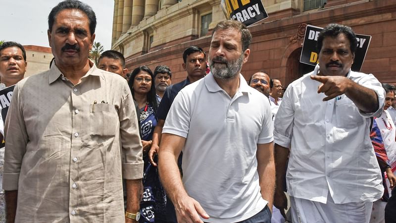 Congress MP Rahul Gandhi with Revolutionary Socialist Party (RSP) MP NK Premachandran and I.N.D.I.A. alliance MPs boycott Lok Sabha proceedings as they hold a march towards the BR Ambedkar statue against the suspension of Leader of Congress in Lok Sabha Adhir Ranjan Chowdhury from the House, at Parliament premises, in New Delhi on 11 August, 2023