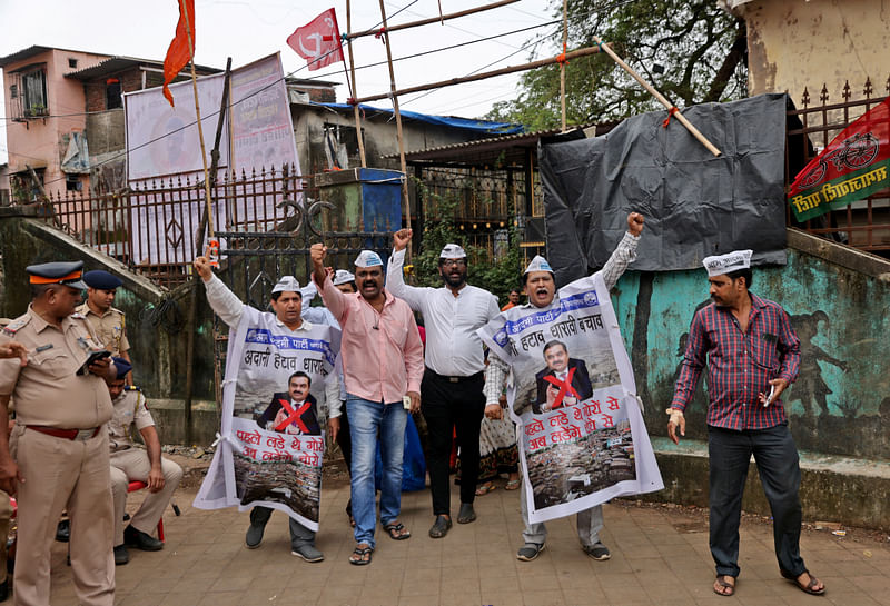 People shout slogans as they wear banners during a protest against the redevelopment of Dharavi, one of Asia's largest slums, by the Adani Group in Mumbai, India, August 9, 2023. Banners read: "Remove Adani, Save Dharavi" and "First we fought the whites now we fight the thieves"