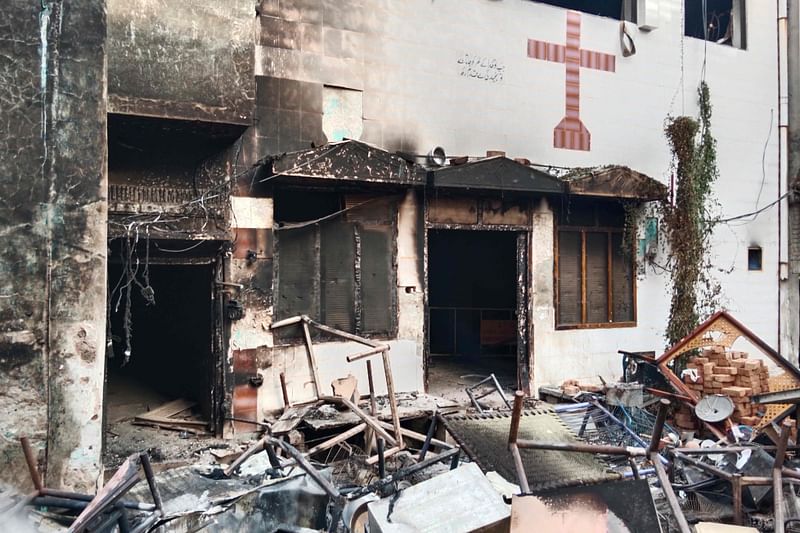 View of a burnt church on the outskirts of Faisalabad on August 16, 2023, following an attack by Muslim men after a Christian family was accused of blasphemy Hundreds of Muslim men set fire to four churches and vandalised a cemetery during a rampage in eastern Pakistan on August 16, officials said, after a Christian family was accused of blasphemy