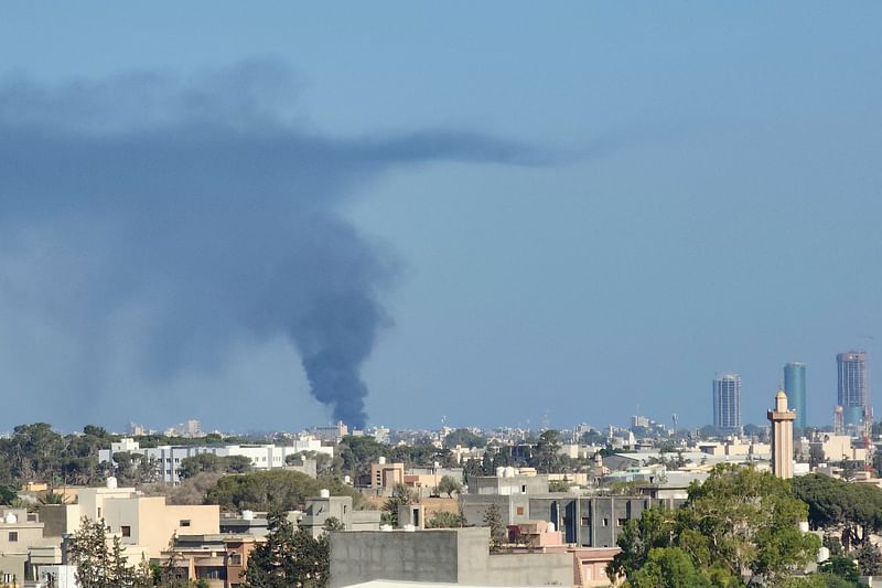 Smoke billows amid clashes between armed groups affiliated with Libya's Tripoli-based Government of National Unity (GNU) on 15 August, 2023