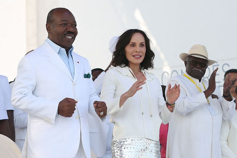 Gabon President Ali Bongo Ondimba (L) and Gabon First Lady Sylvia Bongo Ondimba (C) are seen at the Nzang Ayong stadium in Libreville on 10 July, 2023, a day after he announced that he would seek a third term as the oil-rich African nation's head of state