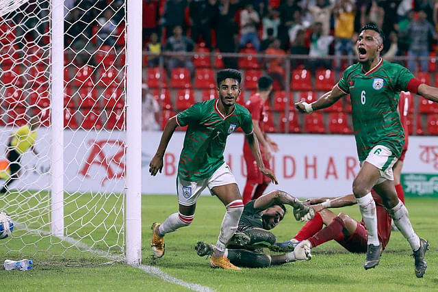 Bangladesh forward Sheikh Morsalin celebrates after scoring with captain Jamal Bhuiyan during their 2nd FIFA friendly against against Afghanistan at the Kings Arena in Dhaka on 8 September 2023