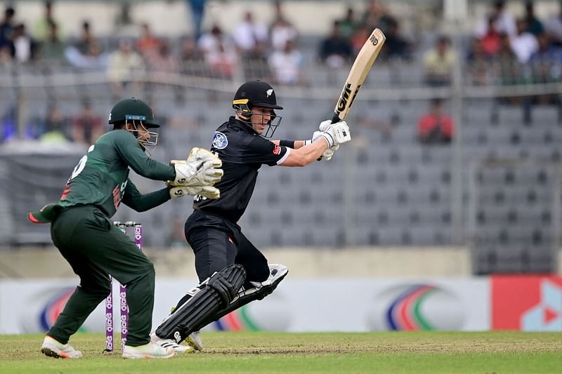 New Zealand's Cole McConchie (R) plays a shot during the second one-day international (ODI) cricket match between Bangladesh and New Zealand at the Sher-e-Bangla National Cricket Stadium in Dhaka on September 23, 2023