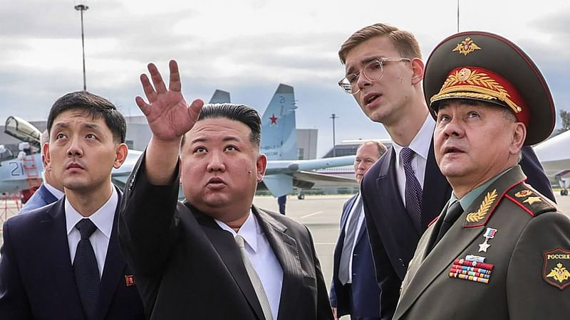 In this handout photograph distributed by the Russian defence ministry, North Korea's leader Kim Jong Un (2nd L) and Russia's defence minister Sergei Shoigu (R) visit Knevichi aerodrome near Vladivostok, Primorsky region on 16 September, 2023