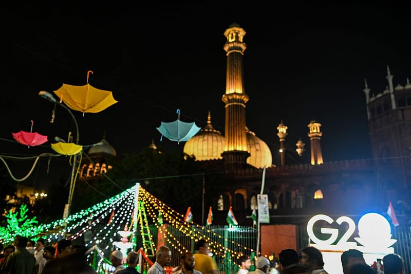 People crowd on the backdrop of decorations around Jama Masjid Mosque ahead of the G20 summit, in New Delhi on 7 September, 2023