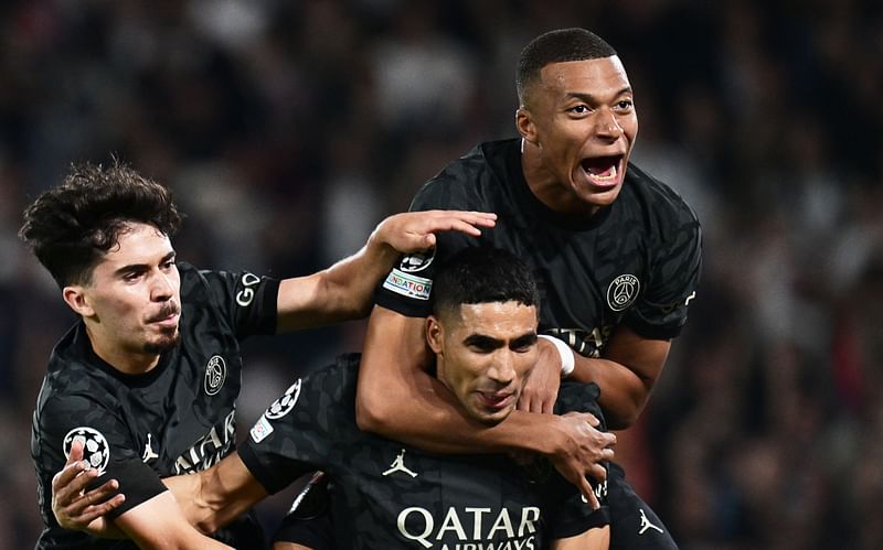 Paris Saint-Germain's Moroccan defender Achraf Hakimi (C) celebrates with Paris Saint-Germain's French forward Kylian Mbappe (R) and Paris Saint-Germain's Portuguese midfielder  Vitinha (L) after scoring a goal during the UEFA Champions League 1st round Group F football match between Paris Saint-Germain (PSG) and Borussia Dortmund (BVB) at the Parc des Princes stadium in Paris on 19 September, 2023