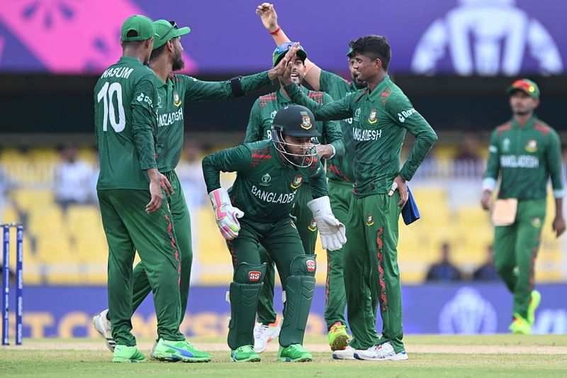 Bangladesh’s Nasum Ahmed celebrates with teammates the wicket of Kusal Mendis during a warm-up match between Bangladesh and Sri Lanka ahead of the ICC World Cup at the Assam Cricket Association Stadium in Guwahati on 29 September 2023