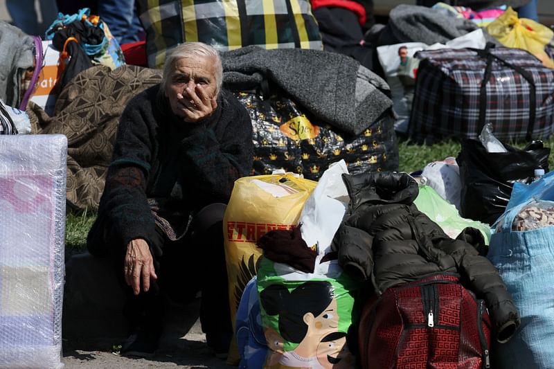 An elederly women sits as she waits among fellow Armenian refugees in Goris on 29 September, 2023 before being evacuated in various Armenian cities, as the exodus from the Nagorno-Karabakh ethnic Armenian enclave following its fall to Azerbaijani forces continued unabated.