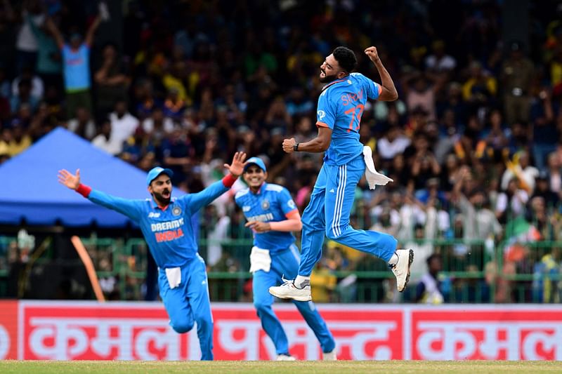 India's Mohammed Siraj celebrates with Virat Kohli and Shubman Gill after taking the wicket of Sri Lanka's Charith Asalanka during the Asia Cup 2023 final between Sri Lanka and India at the R. Premadasa Stadium in Colombo on 17 September 2023