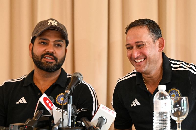 India's chief cricket selector Ajit Agarkar (R) smiles as team captain Rohit Sharma watches during a press conference in Kandy on 5 September 2023