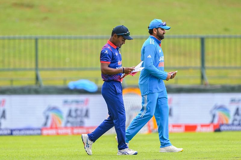 Nepal's captain Rohit Paudel (L) walks with India's captain Rohit Sharma before the start of Asia Cup 2023 cricket match between India and Nepal at the at the Pallekele International Cricket Stadium in Kandy on September 4, 2023