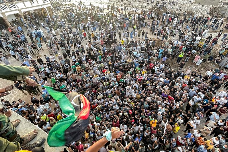 People gather for a demonstration outside the surviving Al-Sahaba mosque in Libya's eastern city of Derna on September 18, 2023, as they protest against government neglect to the two dams which broke and led to the deadly flash floods that hit the city the prior week