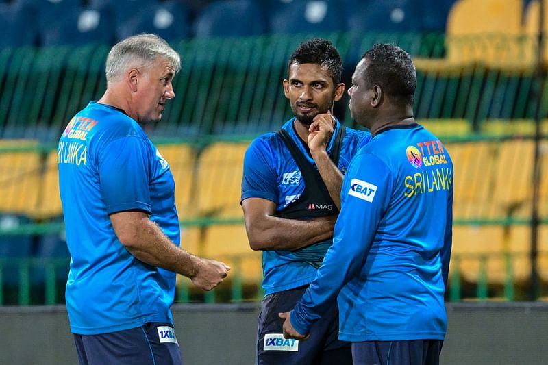 Sri Lanka's coach Chris Silverwood (L) talks with captain Dasun Shanaka (C) during a practice session at the R. Premadasa Stadium in Colombo on September 8, 2023, on the eve of their Asia Cup super four cricket match against Bangladesh