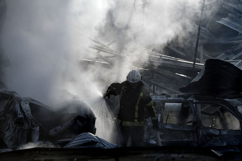 Firefighters push out a fire on an industrial area of the Ukrainian capital of Kyiv, after a massive overnight missile attack to Ukraine on 23 September, 2023