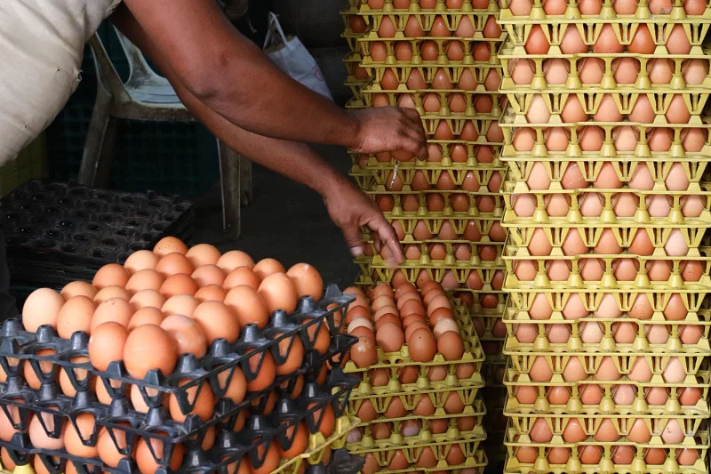 A man prepares eggs at a store in Sylhet.