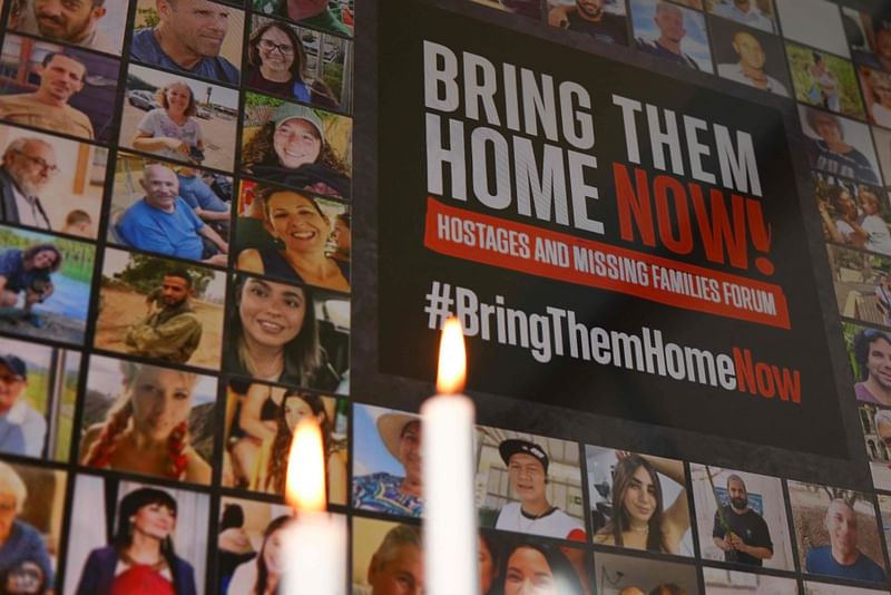 This photograph taken in Brussels on October 26, 2023 shows a poster and candles displayed during a press conference organised by Europe Israel Press Association with families of Israelis killed or held captive by the Palestinian Islamist movement Hamas.